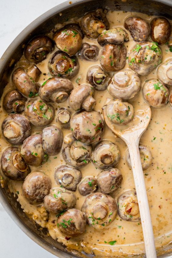 a skillet filled with mushrooms and gravy