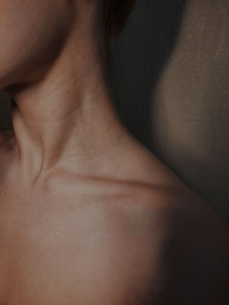 a woman's neck and shoulder is shown in this close - up photo, with the skin visible