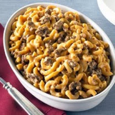 a white bowl filled with macaroni and cheese on top of a red napkin