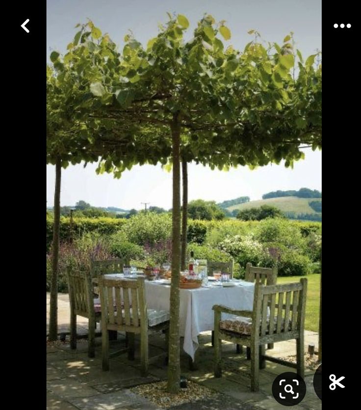 an outdoor dining area with table and chairs