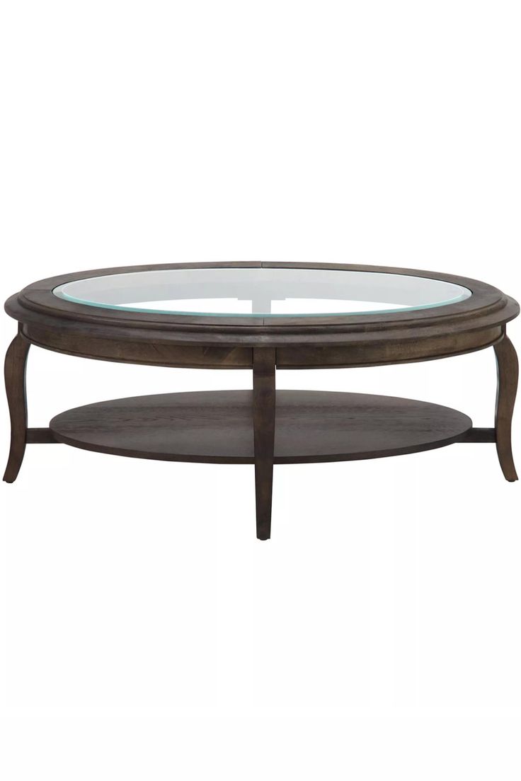 a glass top coffee table with wooden legs and an oval shaped shelf on the bottom