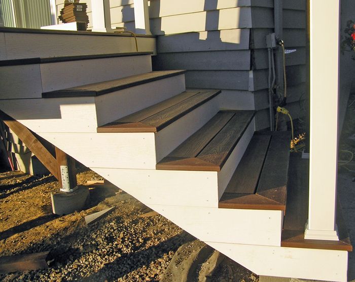 the stairs are made of wood and have metal handrails