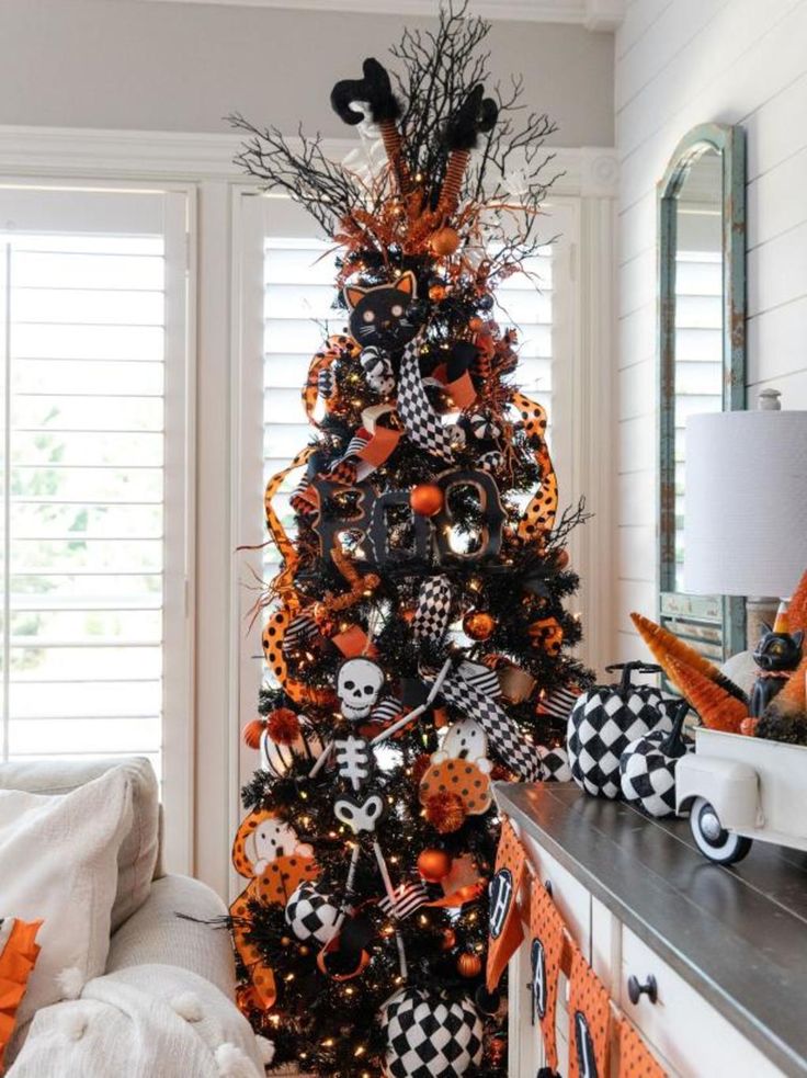 a halloween tree decorated with black and orange decorations