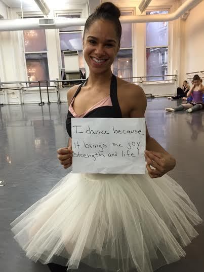 a woman in a tutu holding up a sign