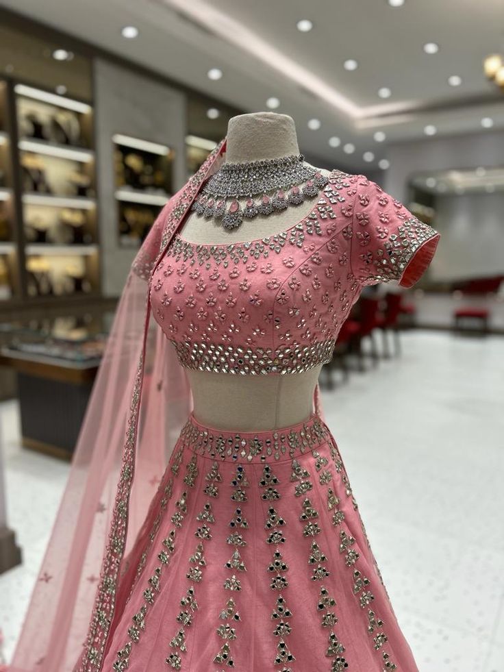 Be the Belle of the Ball in this dazzling bridal lehenga! BL-040 is a showstopper that will keep all eyes on you. Make your special day unforgettable in this exquisite piece full of glitz and glam. Live the fairytale you've dreamt of - and let BL-040 be your magical outfit for your sangeet! Fabric: Net with raw silk li Wedding Embellished Sets For Diwali, Embellished Wedding Sets For Diwali, Embellished Sets For Wedding And Festivals, Embellished Wedding Sets For Festivals, Dola Silk Lehenga For Wedding, Wedding Dola Silk Lehenga, Embellished Choli For Wedding And Festive Occasions, Bollywood Embellished Choli For Wedding, Bollywood Embellished Wedding Choli