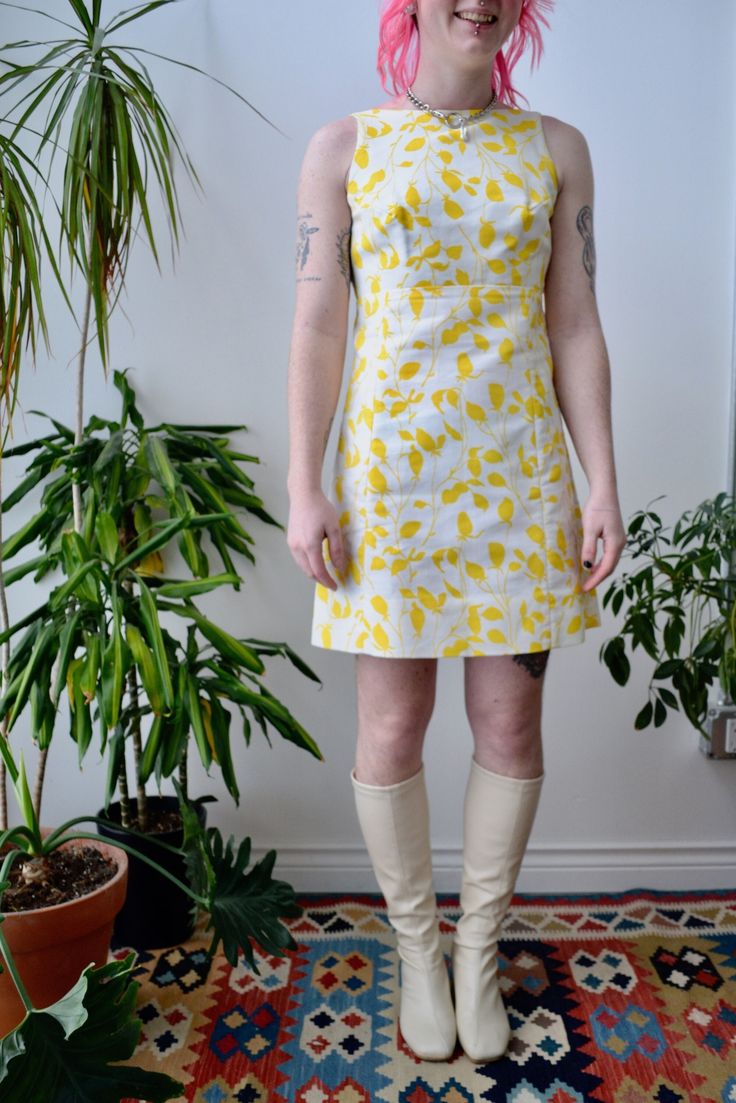 "Yellow and White Sixties/Seventies Mini Mod Dress by \"Lanz Originals\". Hook and Eye Wrap Back Closure. Asymmetrical Bow Detail. Empire Waist. Lined Bodice. Skirt Unlined. No Content Label Excellent Vintage Condition - minor armpit discolouration Fits Size Small/Extra Small Chest - 34\" Waist - 29\" Hip - 38\" Length - 32\" All Sales Are Final. We have taken the time to note all size measurements and the condition of each piece so please look over all the information of the garment you are con Cotton Lined Mod Dress, Mod Style Cotton Lined Dresses, Mod Style Cotton Dress With Lining, Cotton Mod Dress With Lining, Spring Fitted Mod Mini Dress, Fitted Mod Mini Dress For Spring, Lined Mod Summer Dresses, Mod Mini Dress For Spring, Retro Mini Dress For Spring Daywear