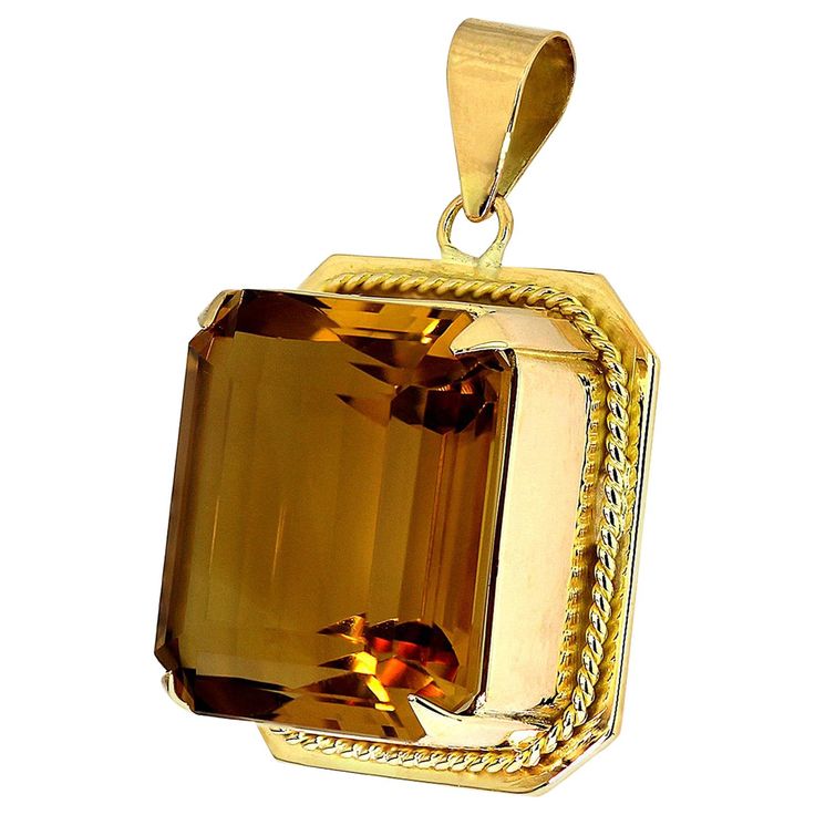 Beautifully composed citrine pendant in 18 carat yellow gold. It features a luxurious glowing fiery yellow orange citrine in a rectangular emerald cut, bordered with a stunning yellow gold rope twist border, and yellow gold pendant bail. The citrine is big, it is a truly bold and powerful piece, and the yellow orange warm tone of the gemstone, harmonises perfectly with the yellow gold. Circa 1960's. 1 x Rectangular emerald cut citrine, approximate weight 40.0 carats Orange Citrine, Marco Bicego, Jaune Orange, Citrine Pendant, Pendant Bails, Warm Tone, Citrine Stone, Yellow Gold Pendants, Stone Cuts