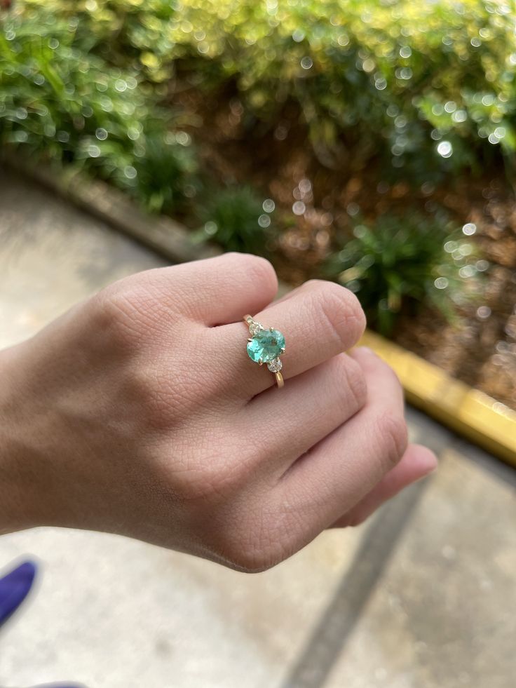 A classic Colombian emerald and diamond three stone ring. Dexterously crafted in gleaming 14K gold this ring features a 2.0-carat natural Colombian emerald-oval cut from the famous Chivor mines. Set in a secure prong setting, this extraordinary emerald has a bright green color and glow. This emerald has very good eye clarity with natural Jardins that occur in all earth mined emeralds. Brilliant round diamonds weighing 0.35pts total accent either side of the emerald. Setting: Three-Stone Metal Pu Oval Emerald Ring In Yellow Gold For Proposal, Green Opal Oval Ring In 14k Gold, Oval Yellow Gold Emerald Ring For Proposal, Heirloom Oval Emerald Ring With Ethical Gemstones, Oval Emerald Ring In 14k Gold For Proposal, Yellow Gold Round Emerald Ring For Proposal, Round Emerald Ring In Yellow Gold For Proposal, Round Yellow Gold Emerald Ring For Proposal, Oval Solitaire Emerald Ring In 14k Gold