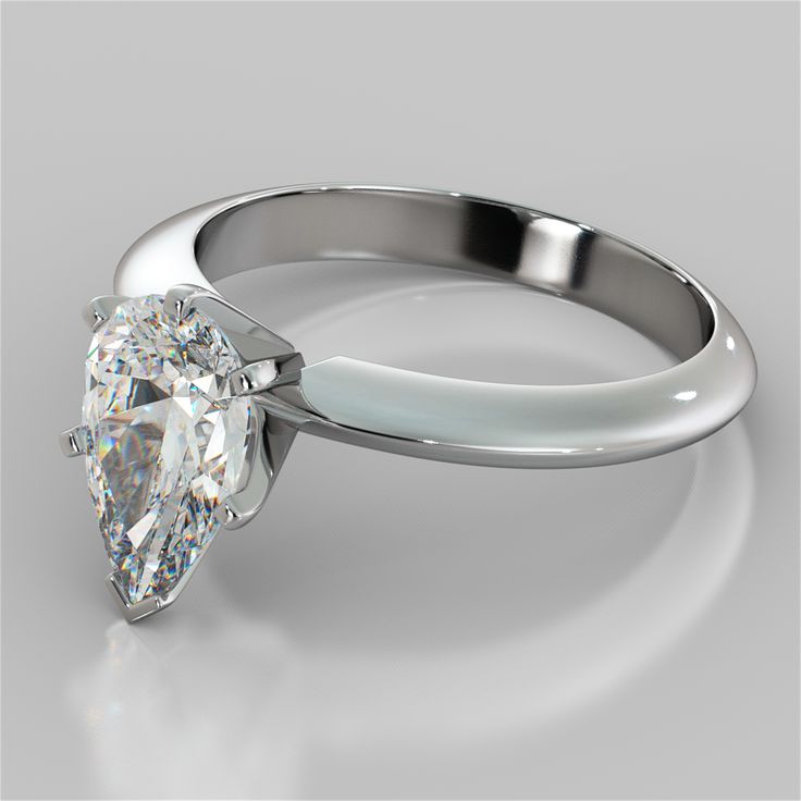 a white gold ring with a pear shaped diamond