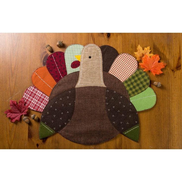 a turkey shaped placemat on top of a wooden table