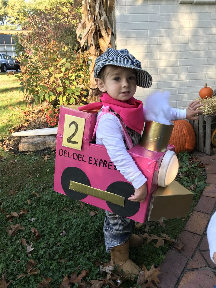 a little boy dressed up in a costume