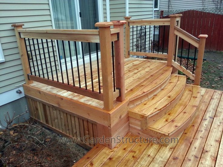 a wooden deck with railing and hand rail