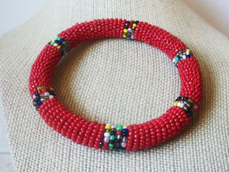 Colorful Glass Seed Beads Flexible Bangle Bracelet Tribal Native Mexican 41217 Flexible and bendable 3/8" in width Measure Your Wrist for Bangle Diameter MMDiameter InchesOrder Bangle Size 60.3 MM2 .37 INSmall 66.7 MM2.62 INMedium 69.9 MM2 .75 INLarge In very nice Vintage condition! Please, see my other listings. Please, check out our other listings and we are happy to combine shipping!  For your consideration featuring this beautiful Vintage jewelry. We are always happy to combine shipping. Please, e-mail us if you any questions. We are adding new items daily and thank you for supporting small businesses. Most of our jewelry is previously owned and in good Vintage condition. Our normal business hours are Monday - Sunday from 10 am - 5 pm. We will respond to e-mails as soon as possible. Th Adjustable Bangle With Round Beads For Festivals, Red Beaded Bangle Bracelets For Festival, Adjustable Beaded Bangle, Adjustable Red Bangle For Festival, Adjustable Beaded Round Bangle, Adjustable Red Bangle For Festivals, Traditional Red Beaded Bangle Bracelet, Red Adjustable Bangle For Festivals, Red Beaded Wristband With Round Beads