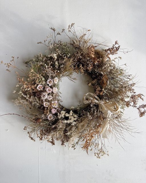 a dried wreath is hanging on the wall