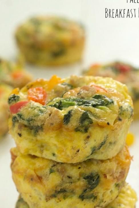 three mini frittatas stacked on top of each other with cheese and vegetables