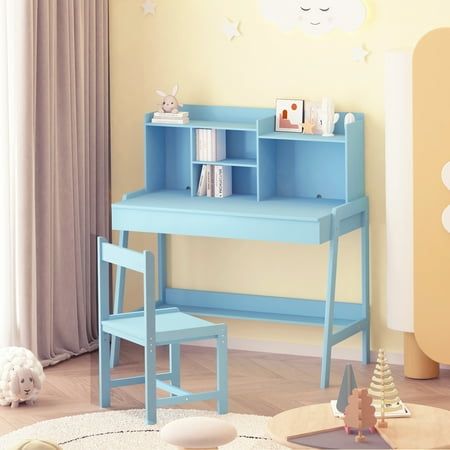 a child's desk and chair in a room with yellow walls, white rugs and wooden flooring