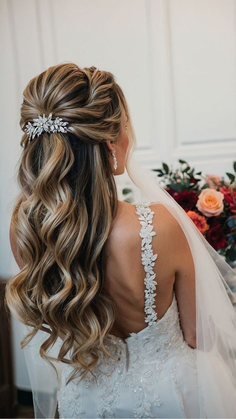 the back of a bride's head with her wedding hair styled in half - updo