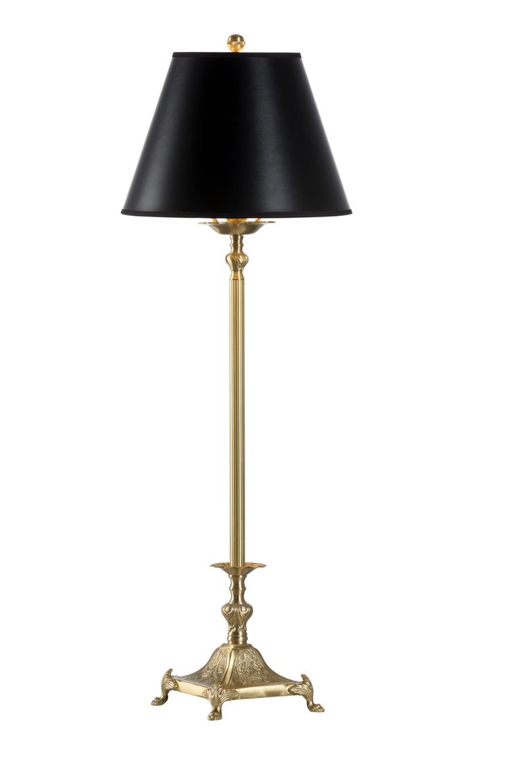 a gold lamp with a black shade on the base and a black lampshade