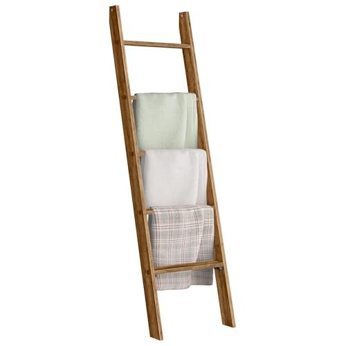 a wooden ladder with towels hanging from it's sides and two folded white towels on top