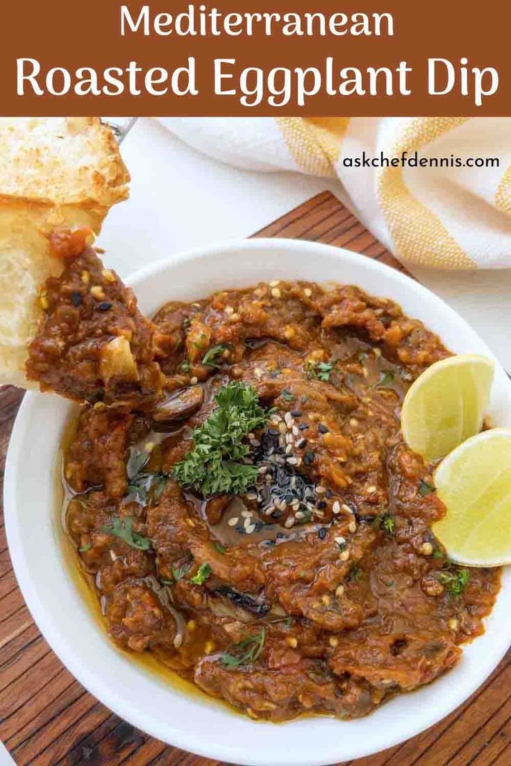 mediterranean roasted eggplant dip in a white bowl with bread on the side