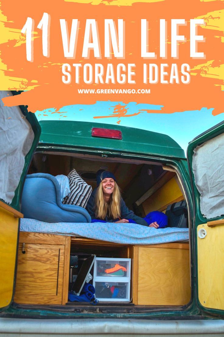 a woman sitting in the back of a green van with its doors open and storage drawers opened