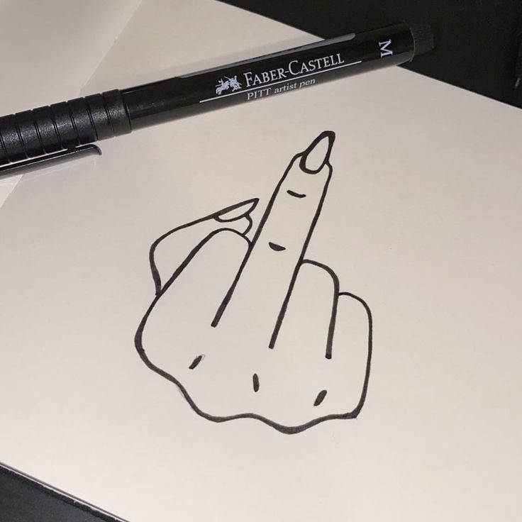 a pen is sitting on top of a paper with a drawing of a pointing finger