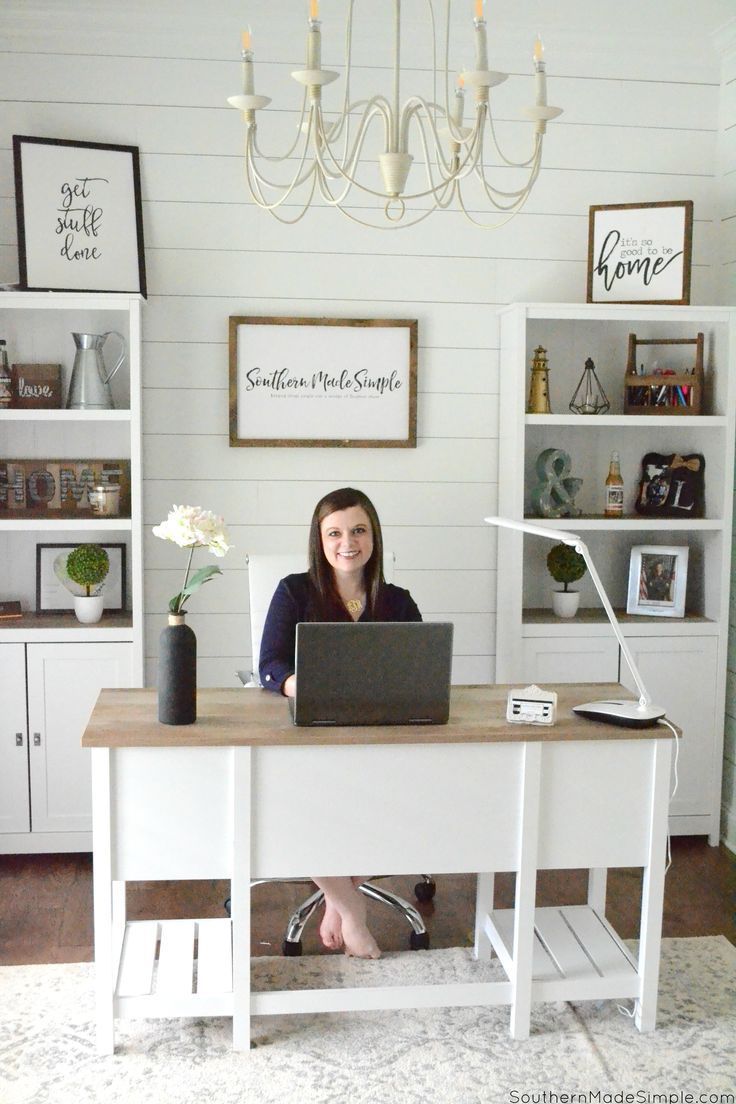 a woman sitting at a desk with a laptop