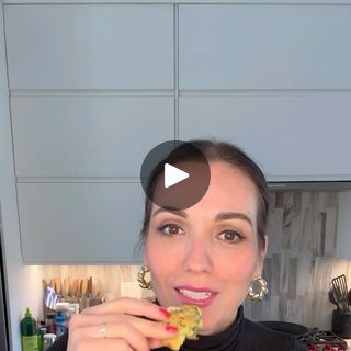 a woman is eating food in the kitchen