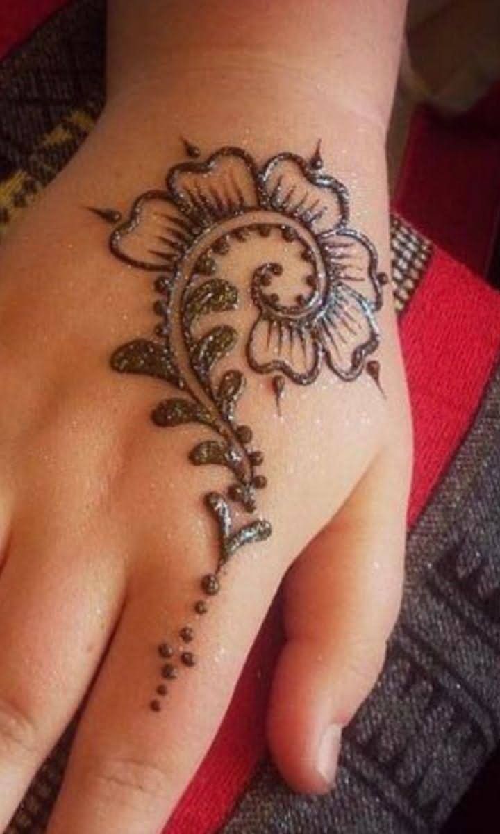 a woman's hand with a henna tattoo on it