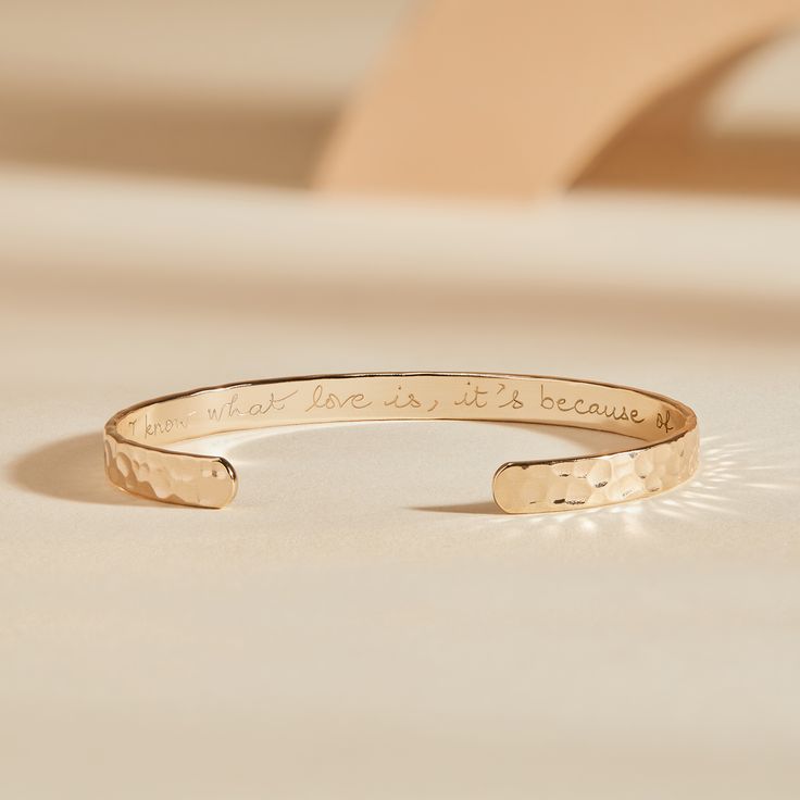 Let the bracelet do with talking with our Hammered Open Bangle. A beautiful hammered texture reveals your personalized message on the inside, wear alone or stack together with other personalized engraved bracelets to tell a special story.18K Champagne Gold Plated, 925 Sterling Silver or 18K Rose Gold PlatedSize: Approx. 2.4 x 2Width of bangle: 0.2The opening of the bangle is 1. The metal has slight flexibility, allowing the wearer to put the bangle on, wear it securely and take it off easilyHand Luxury Minimalist Engraved Bracelets, Luxury Minimalist Engraved Jewelry, Affordable Engraved Wedding Bracelets, Luxury Hammered Gold Bracelet As Gift, Luxury Etched Gold Bracelet Gift, Meaningful Engraved Promise Bracelets, Meaningful Engraved Bracelets For Promise, Inspirational Bangle Bracelets For Anniversary, Inspirational Engraved Promise Bracelets