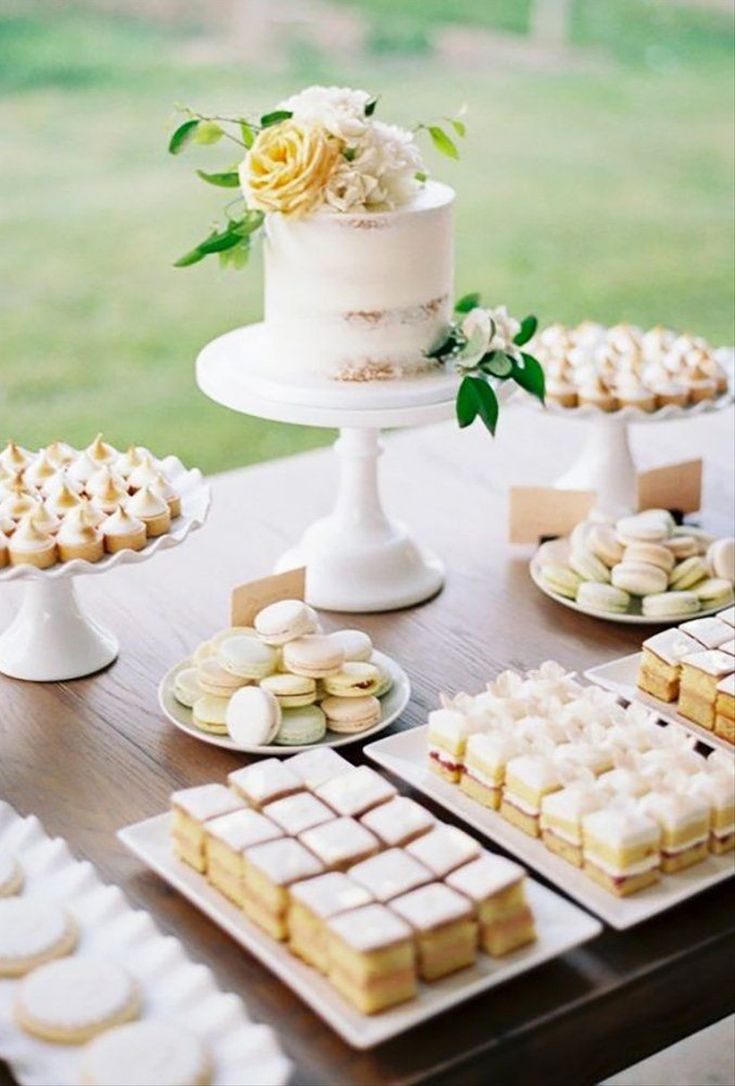 a table topped with lots of desserts and cakes