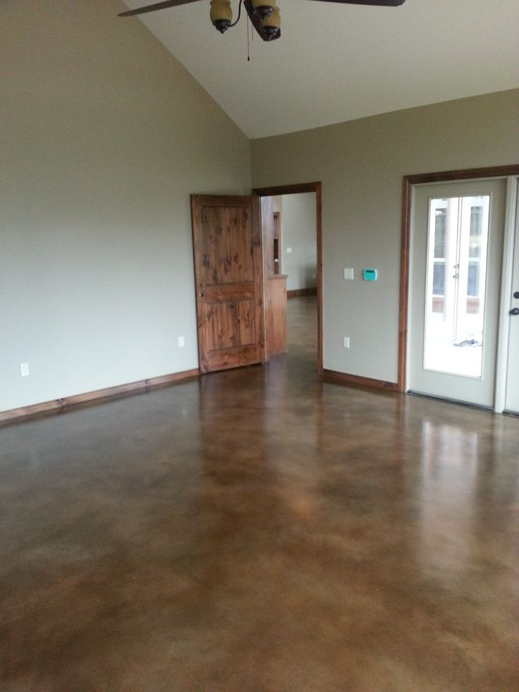 an empty room with wooden doors and ceiling fan