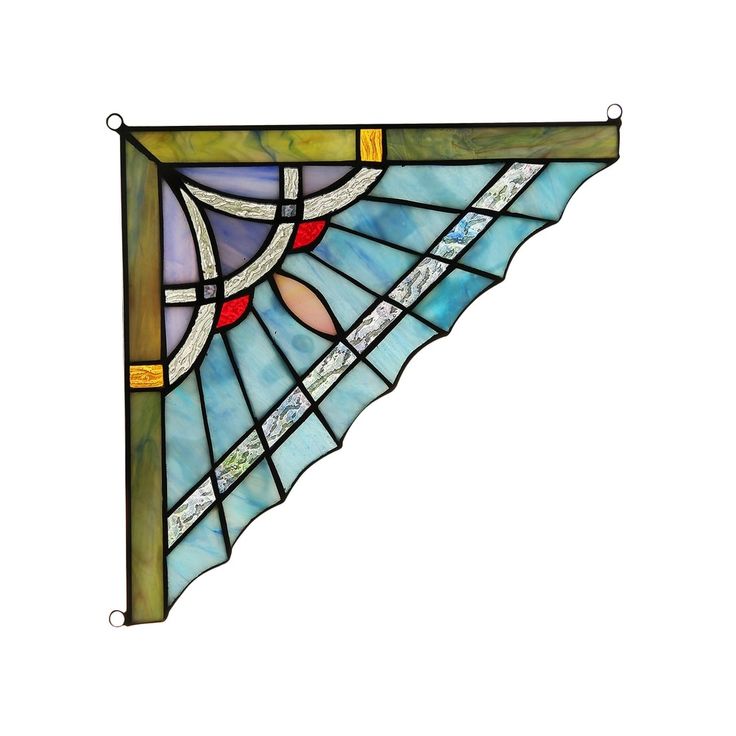 a stained glass window hanging on the side of a wall with an arrow shaped design