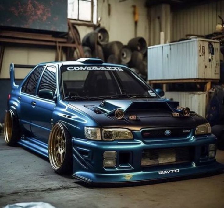 a blue car parked inside of a garage