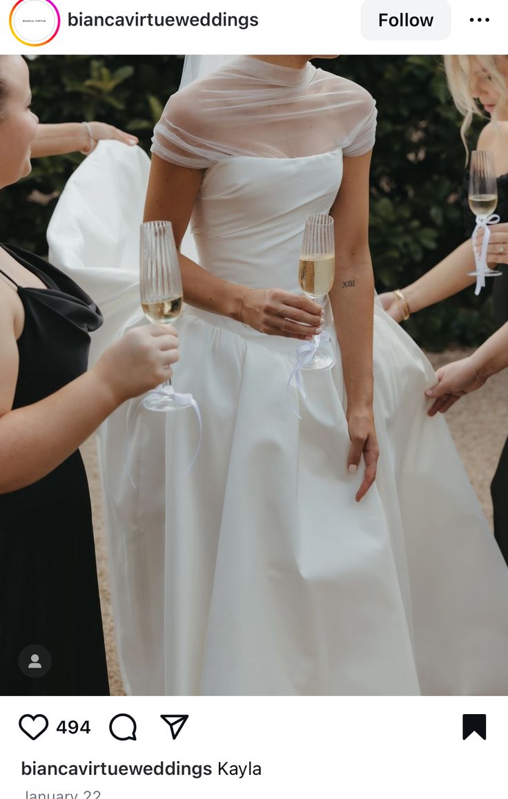 two brides holding champagne flutes in their hands