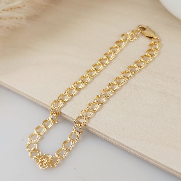 Expertly crafted with a double cable chain design, this 7" gold bracelet adds a touch of elegance to any outfit. Ideal for women, it effortlessly elevates your style with its sophisticated yet versatile look. Own it today and elevate your jewelry collection with this timeless piece. Gold Plated Cable Chain Bracelet, Gold-plated Cable Chain Bracelet, Elegant Everyday Cuban Link Bracelet With Adjustable Chain, Everyday Yellow Gold Charm Bracelet With Extender, Gold Plated Cable Chain Bracelet For Formal Occasions, Formal Gold-plated Cable Chain Bracelet, Gold Cable Chain Bracelet As Gift, Everyday Gold-plated Cable Chain Bracelet, Classic Adjustable Chain Link Charm Bracelet