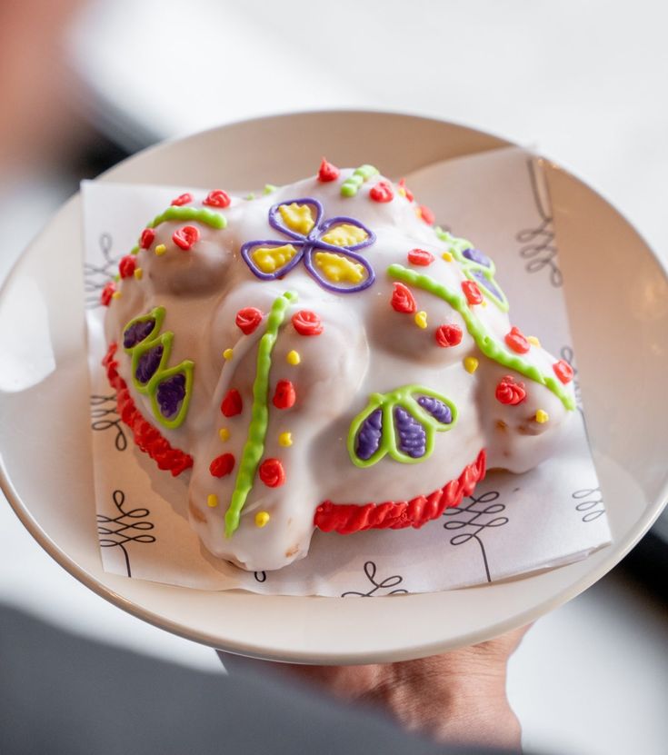 a white plate topped with a cake covered in icing