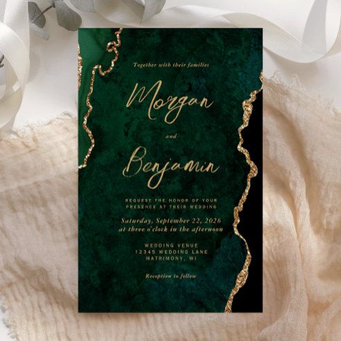 a green wedding card with gold foil on it