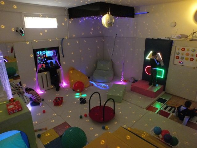 a living room filled with furniture and colorful lights