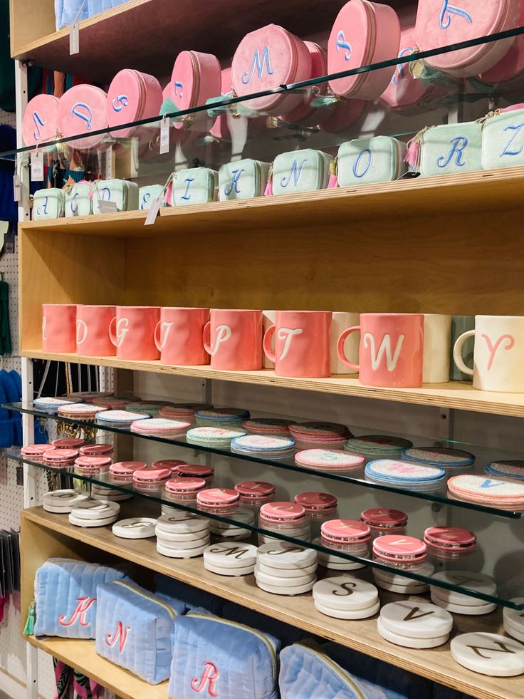 the shelves are filled with many different types of cakes and cupcakes on display