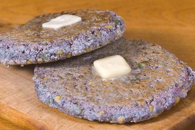 there are two cookies that have been made with blueberries and white cheese on them