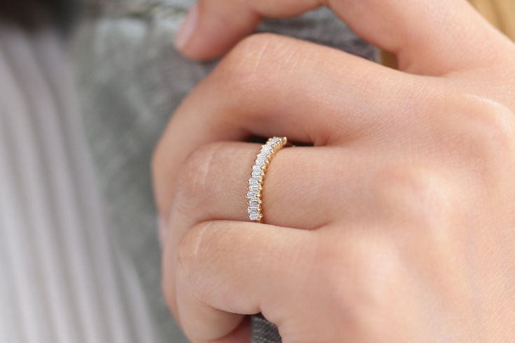 a woman's hand with a diamond ring on her finger