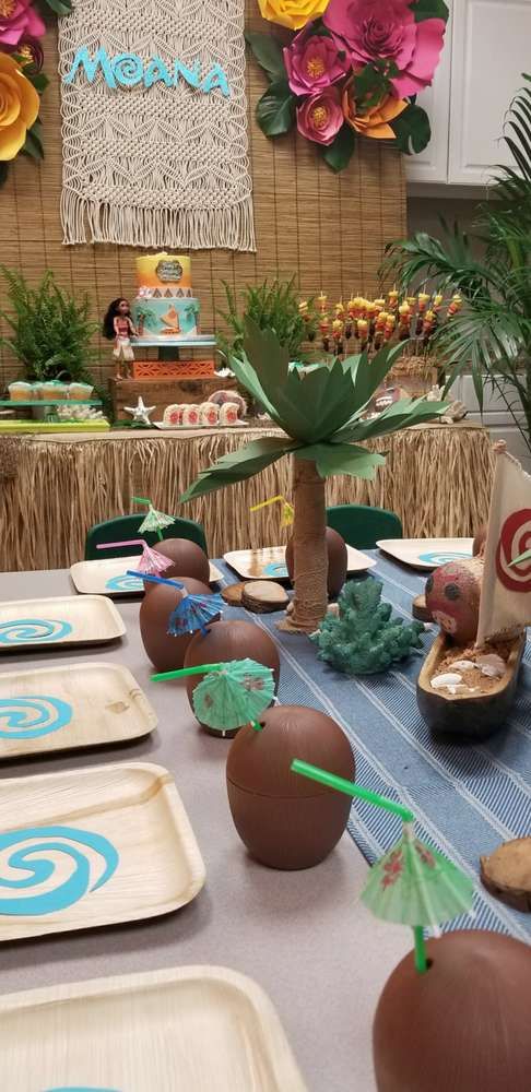 a table topped with lots of desserts covered in frosting and decorated like palm trees