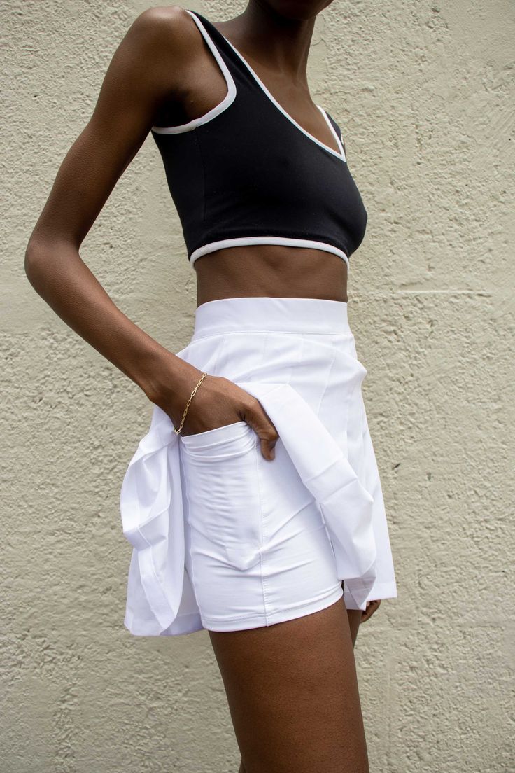 High-rise waist and short hemline create a flattering 70�’s-inspired fit.  The skirt is made with lightweight, flowy fabric meant for movement and breathability 70s Workout Clothes, 70s Workout, Fit Skirt, Tennis Skirts, Flowy Fabric, Sport Tennis, Compression Shorts, Fitted Skirt, Tennis Skirt