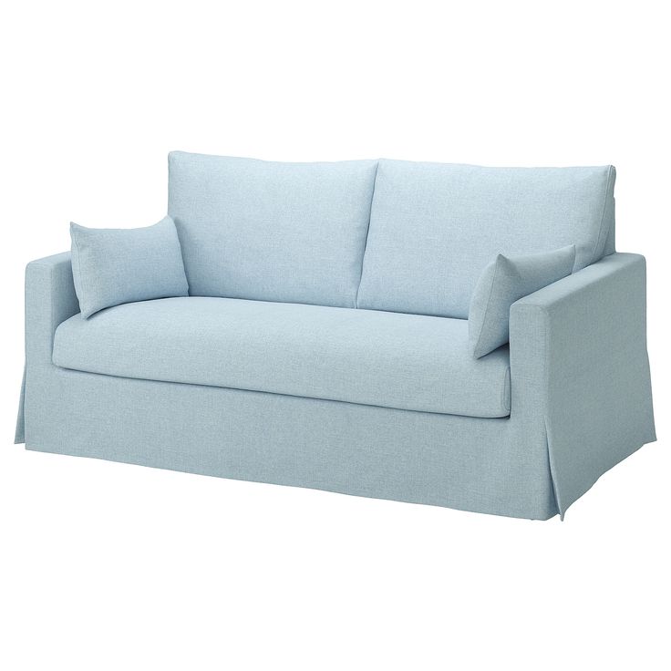 a light blue couch with two pillows on the back and one arm folded over it