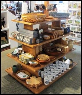 an assortment of items on display in a store with shelves full of books and other things