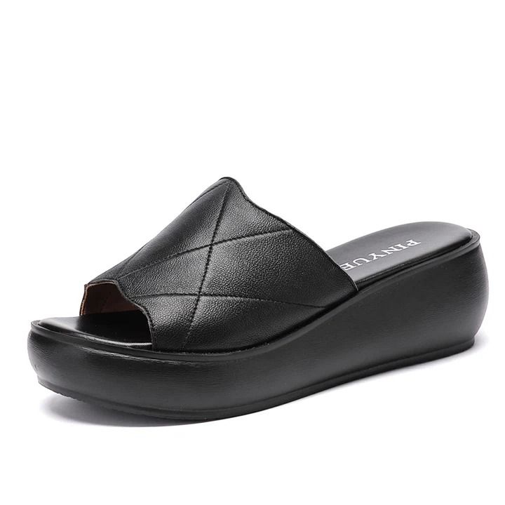 These Aurora women's platform slippers by USS Shoes feature genuine leather uppers, a patterned geometric design, and a TPU outsole. Fitting true to size, are finished with a lightweight and flexible latex insole. The platform wedge gives them a fashionable edge while providing comfortable support, making them perfect for both indoor and outdoor wear. They are soft and comfortable, wear your best color black, green or red, and you will look stylish. Modern Black Platform Slippers With Textured Sole, Modern Platform Slide Slippers With Cushioned Footbed, Modern Cushioned Platform Slide Slippers, Modern Open Toe Platform Slippers With Textured Sole, Leather Platform Slide Slippers With Rubber Sole, Leather Slide Platform Slippers With Rubber Sole, Black Leather Platform Slippers With Thick Bottom, Modern Black Leather Platform Slippers, Modern Black Platform Slippers With Rubber Sole