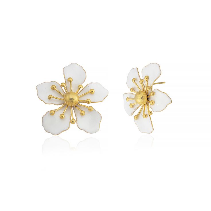 The magnolia flower meaning is attached with the symbols of nobility, perseverance, and love of nature. Soft and subtle in color yet strong in appearance, the flower is representative of the beauty encompassing femininity and gentleness. These earrings are handmade with 22K gold plated brass and enamel. These nickel free earrings are for pierced ears. They come as a pair with both butterfly and silicone earring backs. These beautiful earrings come with the Milou Jewelry box For avoiding damage to your jewels, take care that they do not contact hard chemicals. In order to prevent friction and contact origin minor damages, keep the jewels you are not using in their original package or in a protective casing. In order to keep your jewels clean, wipe them with the help of a soft fabric after u Elegant White Flower Earrings, Elegant Birth Flower Earrings, Elegant Blossom Earrings For Gift, Elegant Blossom Color Flower Earrings For Gift, Elegant White Petal Flower Earrings, Classic White Flower Jewelry, Classic White Flower-shaped Jewelry, White Feminine Earrings With Flower Decoration, Elegant White Flower Pendant Earrings