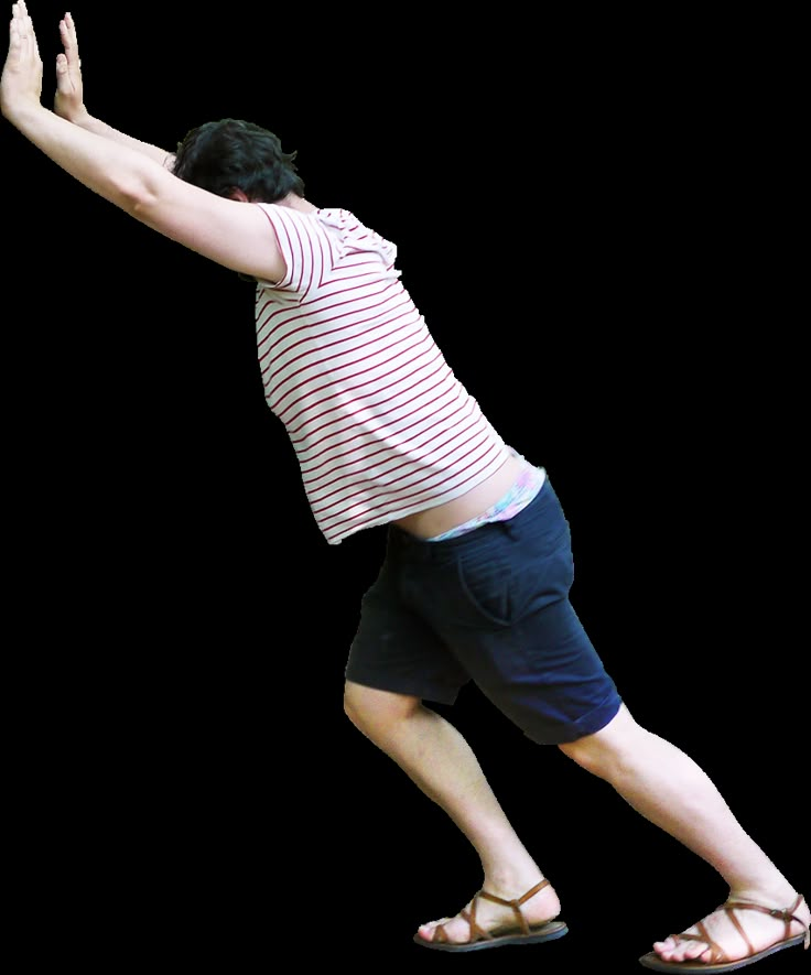 a man in striped shirt catching a frisbee with both hands on white background