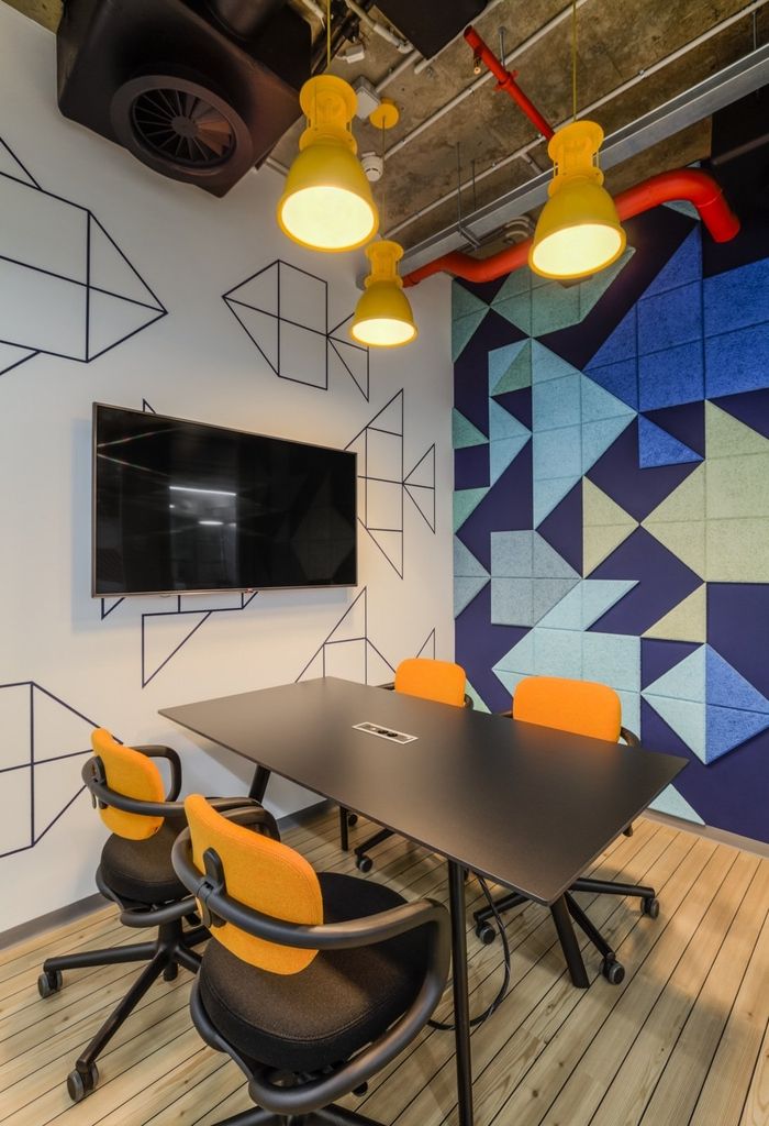 a conference room with chairs and a flat screen tv mounted on the wall above it